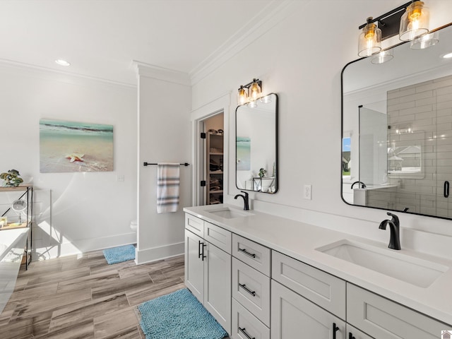 bathroom with ornamental molding, vanity, toilet, and an enclosed shower