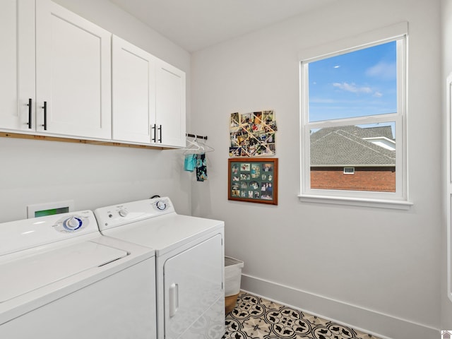 laundry room with cabinets, tile patterned flooring, and washer and dryer