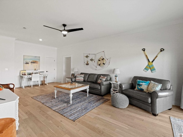 living room with ornamental molding, ceiling fan, and light hardwood / wood-style flooring