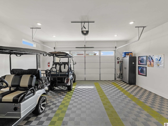 garage with stainless steel refrigerator and a garage door opener