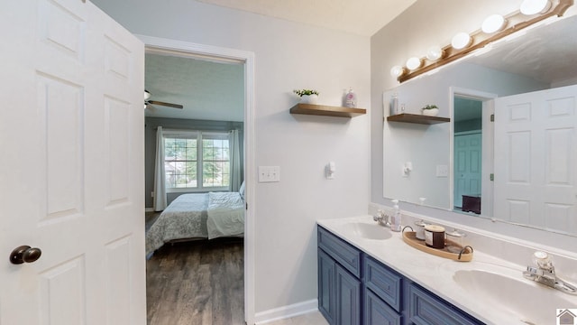 bathroom with ceiling fan, hardwood / wood-style flooring, vanity, and a textured ceiling