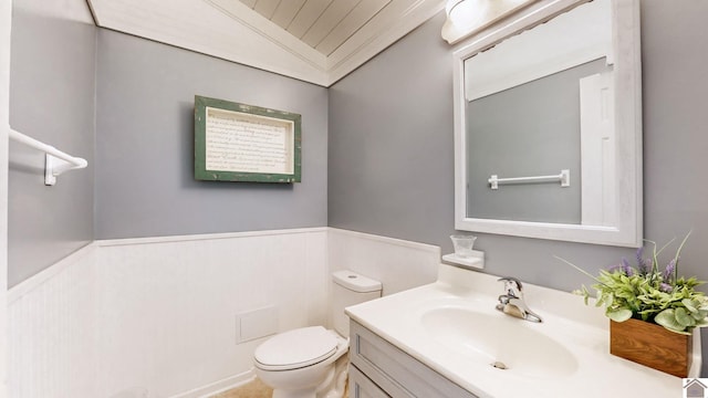 bathroom with vanity, lofted ceiling, and toilet