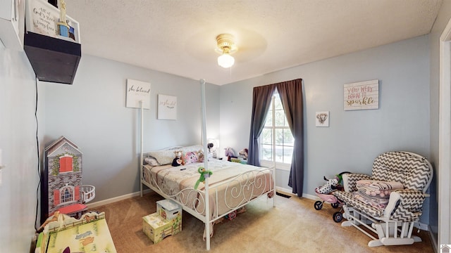 bedroom featuring a textured ceiling, light carpet, and ceiling fan