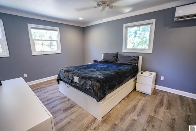 bedroom featuring crown molding, ceiling fan, a wall unit AC, and light hardwood / wood-style flooring