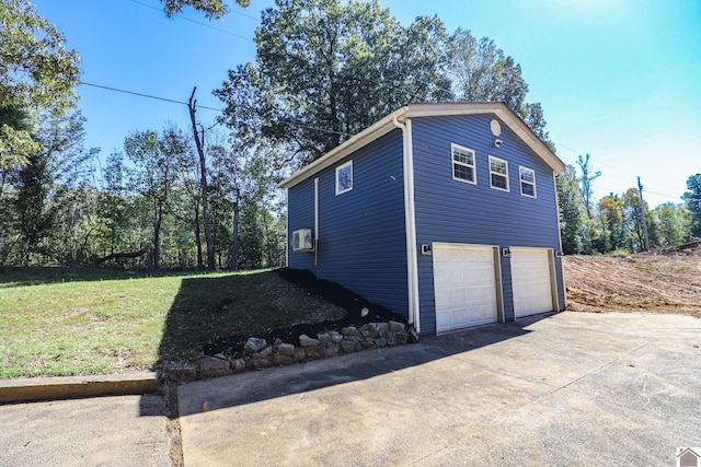 view of side of property featuring cooling unit, a yard, and a garage