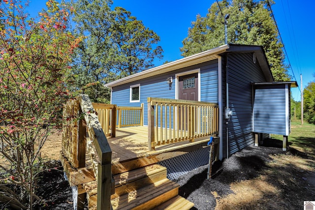 rear view of house with a wooden deck