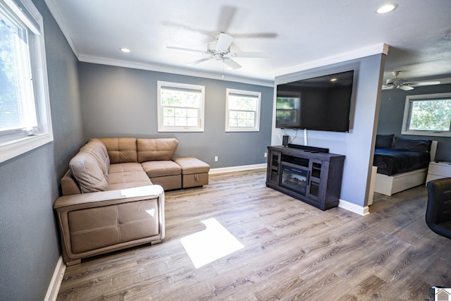 living room featuring ornamental molding, ceiling fan, and hardwood / wood-style flooring