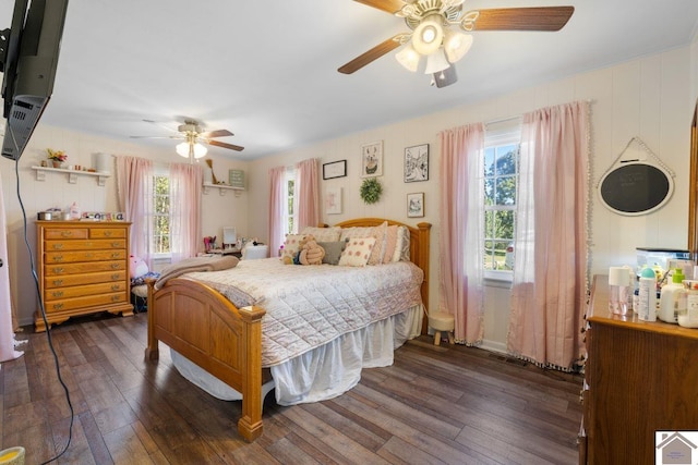 bedroom featuring multiple windows, ceiling fan, and dark hardwood / wood-style flooring