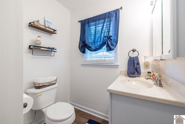 bathroom with vanity, hardwood / wood-style floors, and toilet