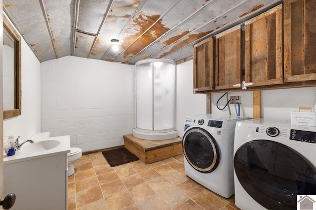 washroom with washing machine and dryer and sink