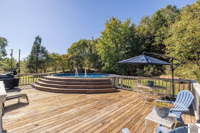 deck with a fenced in pool