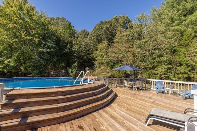 view of swimming pool with a deck