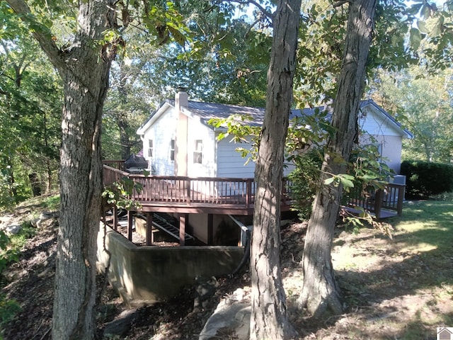 rear view of property featuring a deck