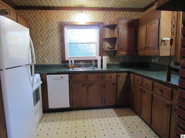 kitchen with white appliances, ornamental molding, and sink