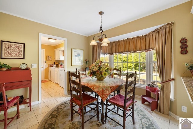 tiled dining room with an inviting chandelier and ornamental molding