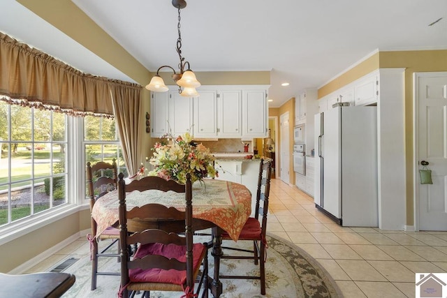 dining space featuring a notable chandelier and light tile patterned floors