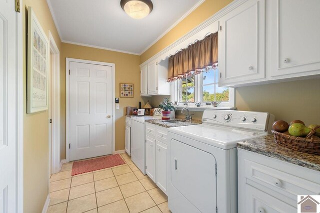 laundry room featuring light tile patterned flooring, ornamental molding, sink, cabinets, and separate washer and dryer