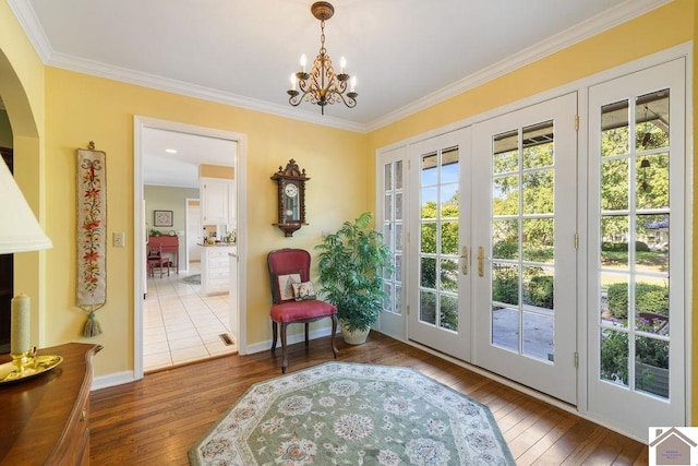 entryway featuring french doors, dark hardwood / wood-style floors, and crown molding