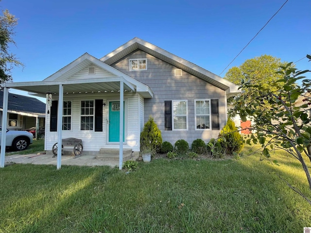 bungalow-style home with a front lawn