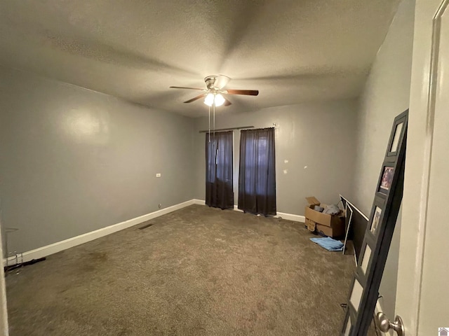 carpeted spare room with ceiling fan and a textured ceiling