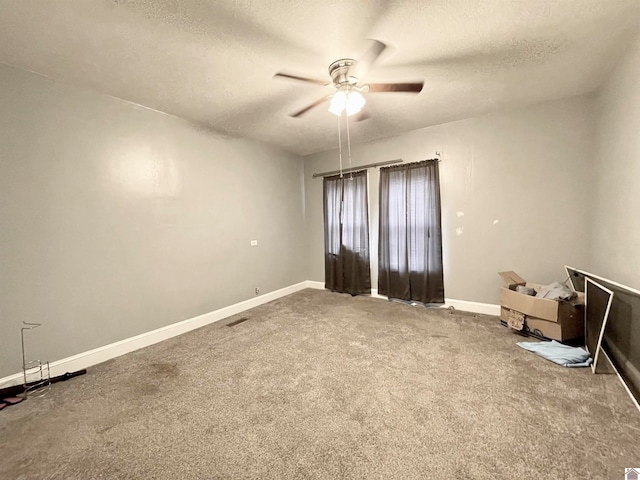 carpeted empty room featuring a textured ceiling and ceiling fan