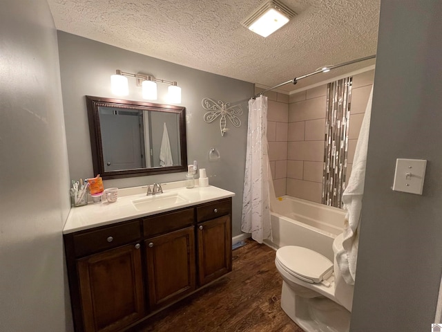 full bathroom with shower / tub combo, toilet, hardwood / wood-style floors, vanity, and a textured ceiling