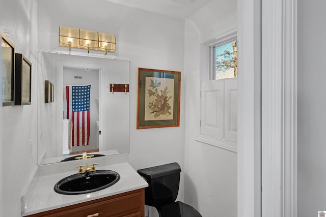 bathroom with vanity and toilet