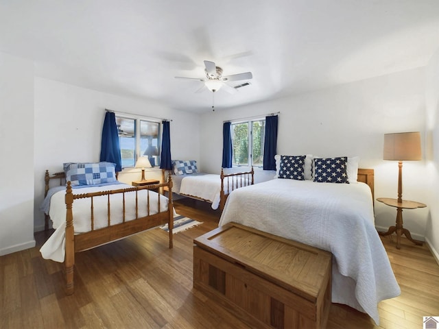 bedroom featuring wood-type flooring and ceiling fan