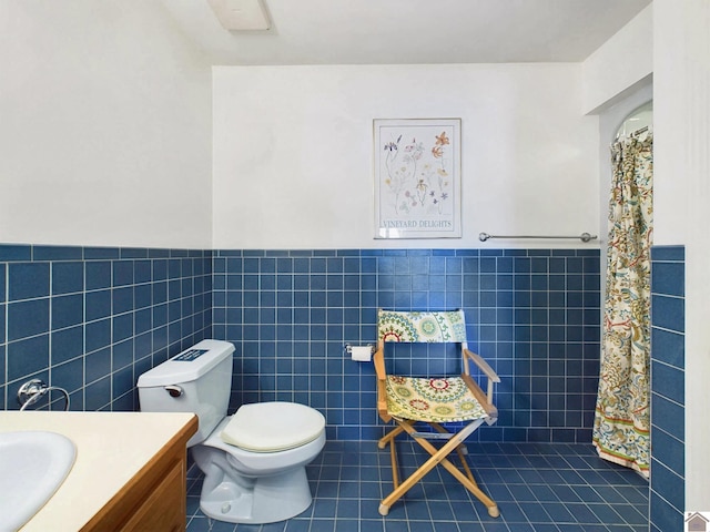 bathroom with vanity, tile walls, toilet, and tile patterned floors