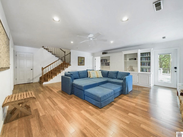 living room with ceiling fan and light wood-type flooring