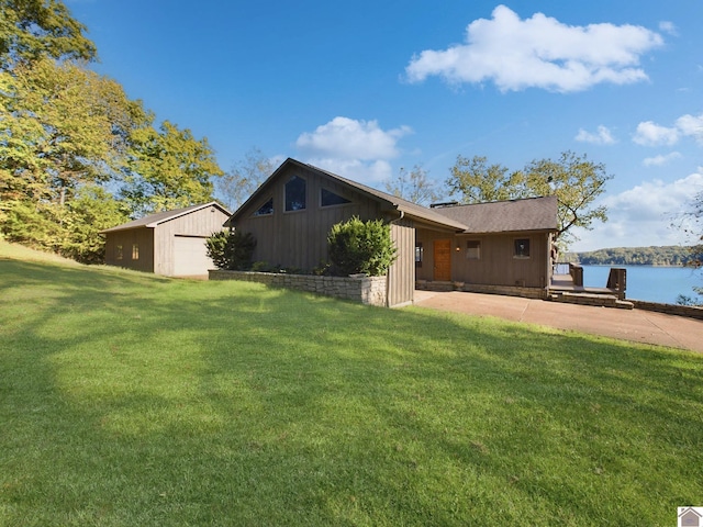 exterior space with a water view, an outdoor structure, and a garage