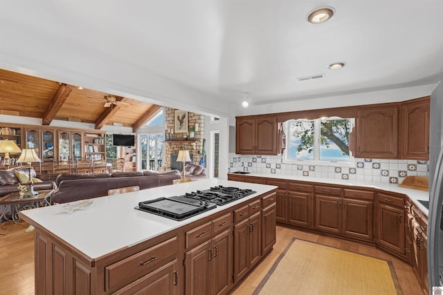 kitchen with light wood-type flooring, decorative backsplash, a center island, and wood ceiling