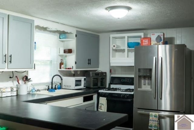 kitchen featuring white appliances and a textured ceiling