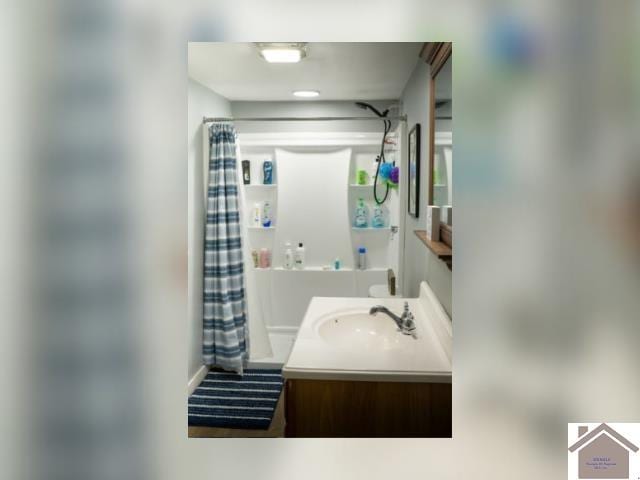 bathroom featuring vanity and a shower with shower curtain