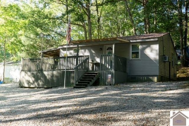 rear view of house with a wooden deck