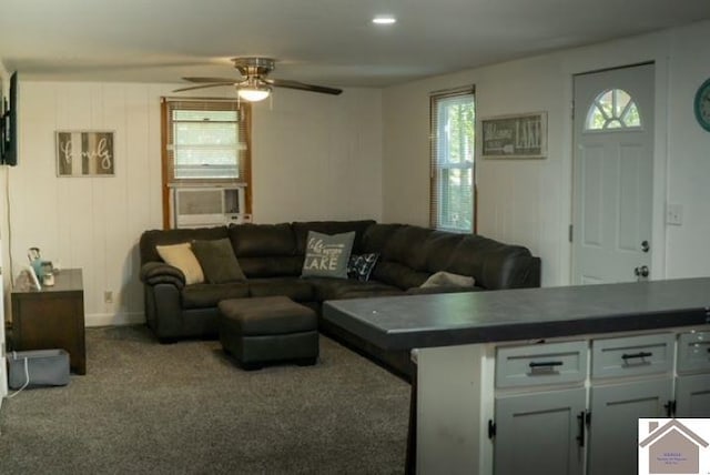 carpeted living room with cooling unit and ceiling fan