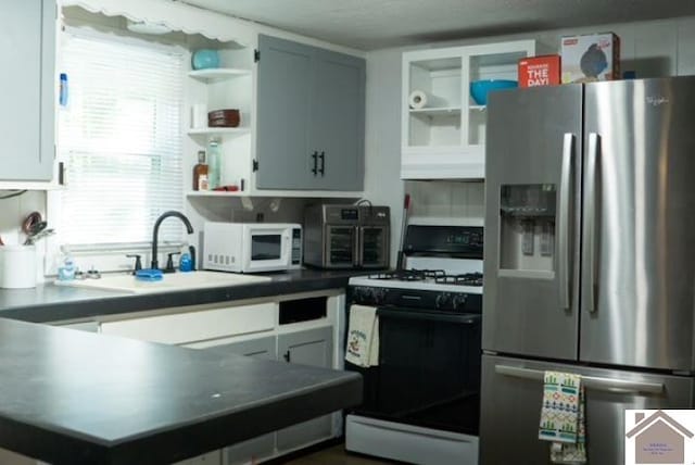 kitchen featuring white appliances, white cabinets, sink, and a textured ceiling