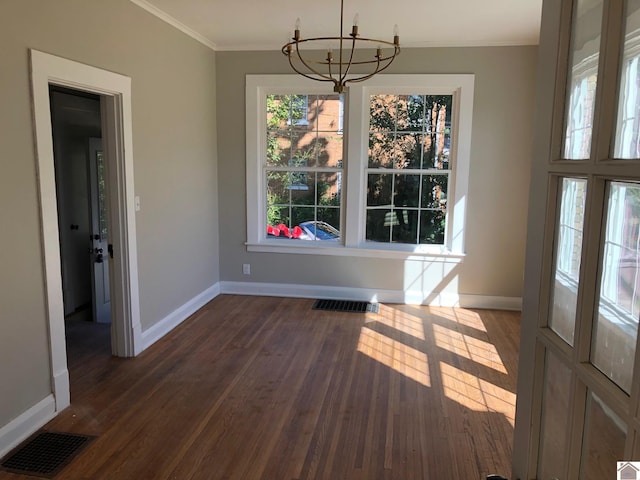 unfurnished dining area featuring crown molding, a chandelier, and dark hardwood / wood-style flooring