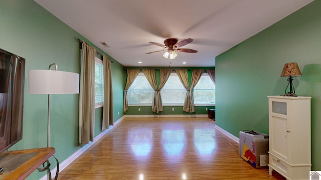 spare room featuring ceiling fan and light hardwood / wood-style floors