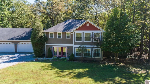 view of front facade with a garage and a front lawn