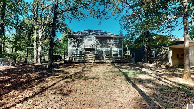 back of property with a wooden deck