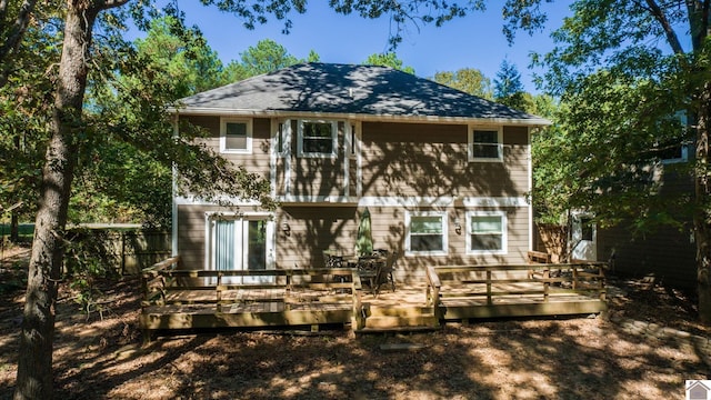 back of house with a wooden deck