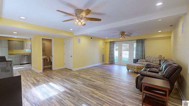 living room with light wood-type flooring, ceiling fan, and french doors