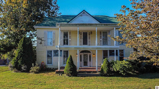 view of front of house featuring a front yard and covered porch