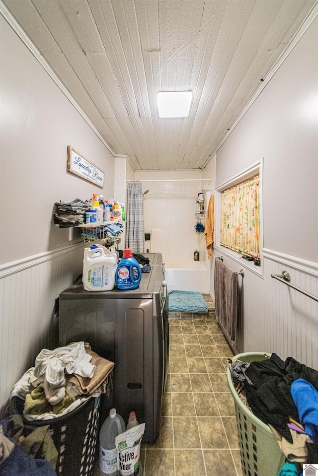 clothes washing area featuring washing machine and dryer, wood ceiling, tile patterned floors, and ornamental molding