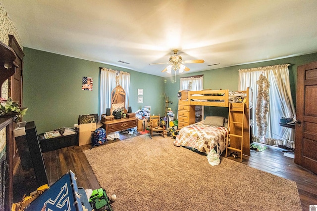 bedroom with ceiling fan and dark hardwood / wood-style floors