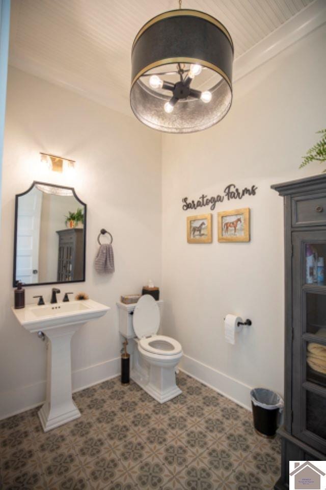 bathroom with toilet and wooden ceiling