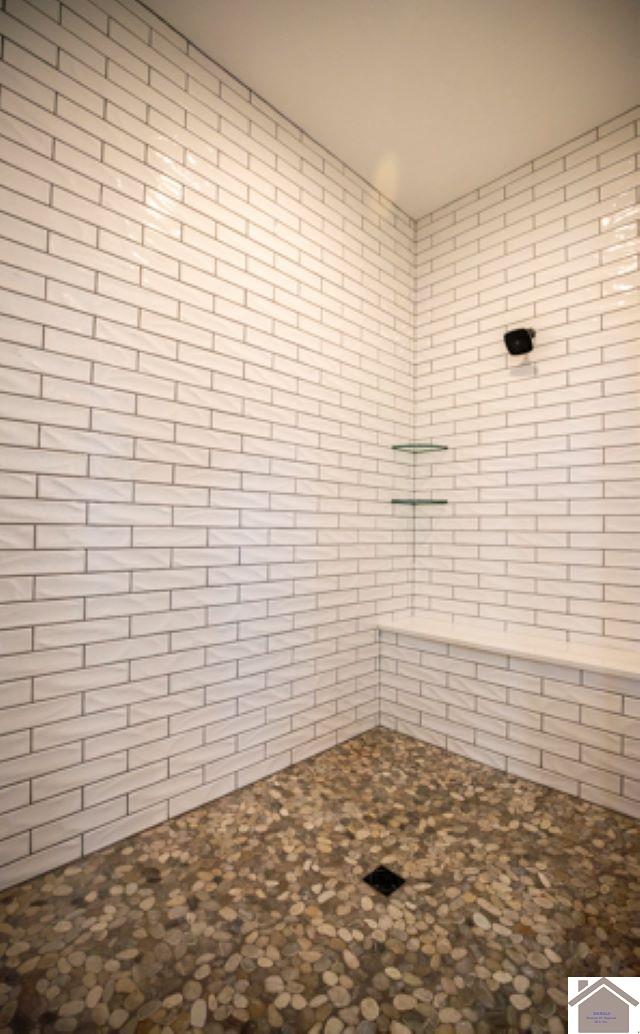 bathroom with tiled shower