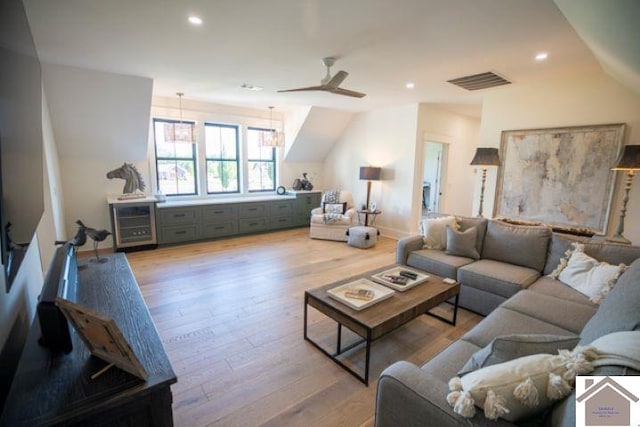 living room featuring light hardwood / wood-style flooring and ceiling fan