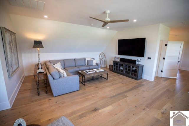 living room with light wood-type flooring, ceiling fan, and lofted ceiling